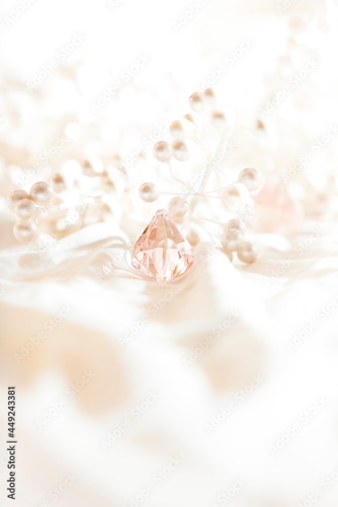 white pearls and pink jewels nestled in white silk white pearls and pink jewels nestled in white silk