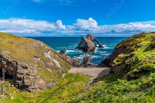 A view of the cliffs and the impressive Bow Fiddle Rock at Portknockie, Scotland on a summers day photo