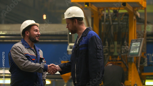 Professional technician engineer and inspector hand shake in factory © nimito