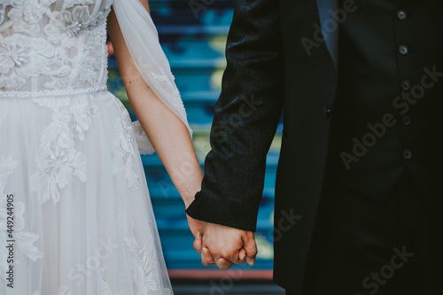 bride and groom holding hands