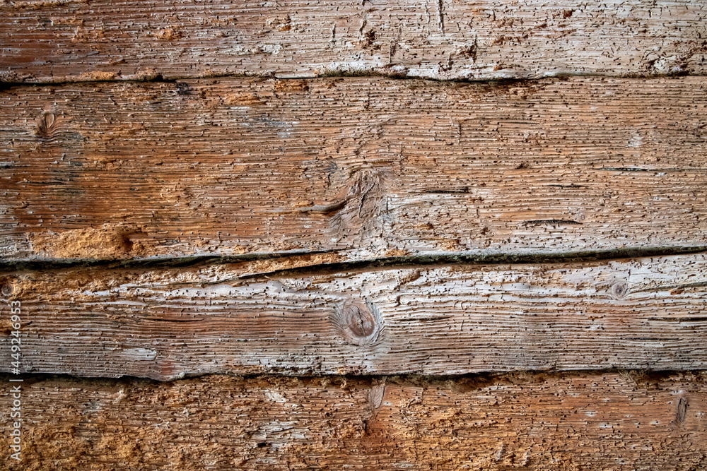 Very old wooden wall eaten by woodworm as background or texture Very old wooden wall eaten by woodworm as background or texture