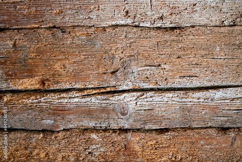 Very old wooden wall eaten by woodworm as background or texture