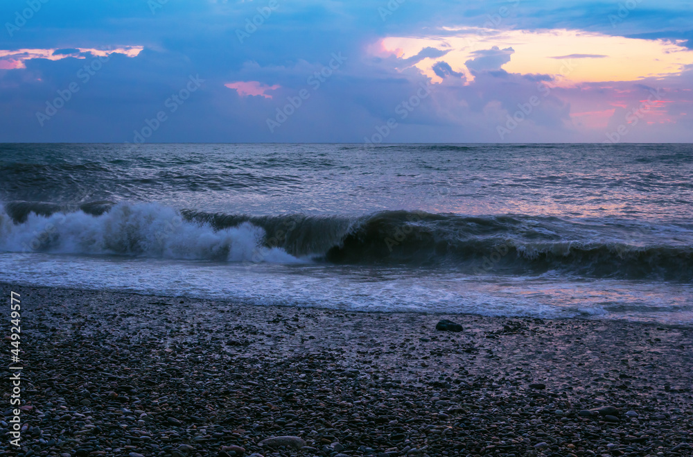 Beautiful waves on the sea after sunset