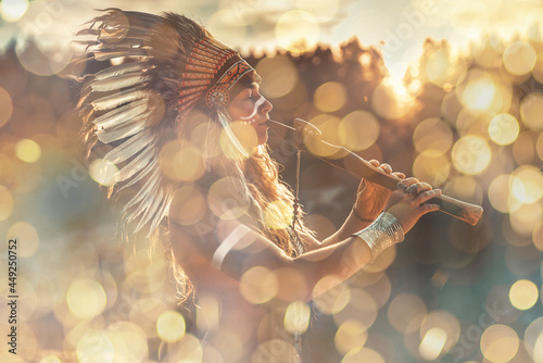 Fotografia beautiful shamanic girl playing on shaman flute in the nature.