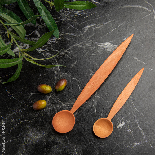 wooden spoons on the table with olives