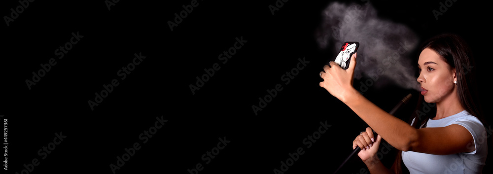 girl smokes a hookah and takes a selfie on a mobile phone. Fashion. Space for text. Banner