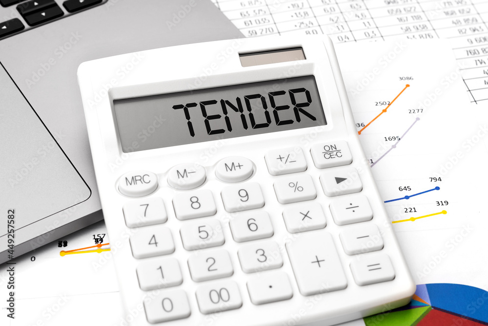 Word TENDER on calculator, laptop, chart, diagram, documents Word TENDER on calculator, laptop, chart, diagram, documents