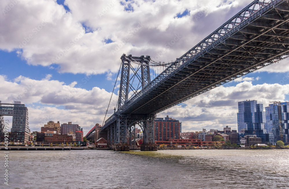Naklejka premium A picture of Williamsburg Bridge in New York City, USA. In the picture one can see the East River and Manhattan skyline
