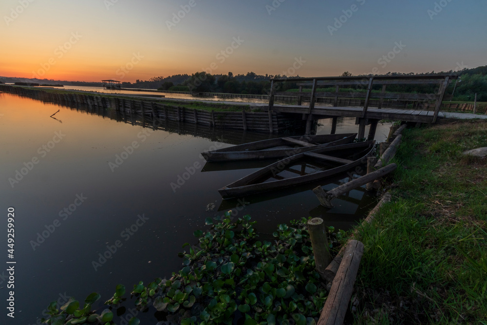 The Pateira de Fermentelos lake at sundown, with a sinking boat, Portugal