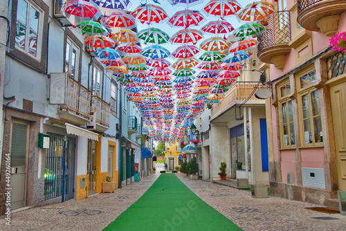 Colorful umbrellas in the street during the Agitágueda street festival in Águeda, Portugal photo