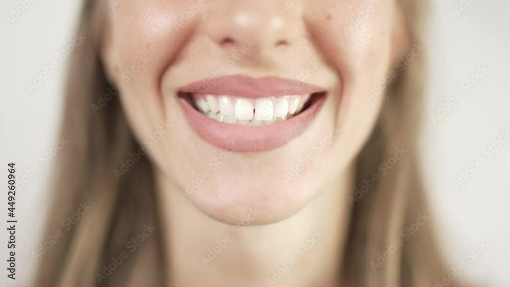 Close up of smiling teeth isolated. Detail of a smile woman. Young successful girl is smiling. Dentistry and teeth whitening concept Close up of smiling teeth isolated. Detail of a smile woman. Young successful girl is smiling. Dentistry and teeth whitening concept