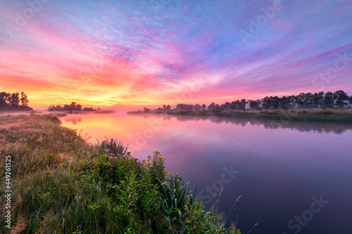 Colorful sunrise over the river banks