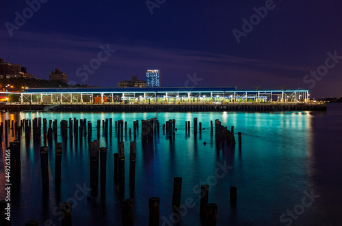 East river and the Brooklyn Bridge Park Basketball Courts seen from Pier 1 Salt Marsh in Brooklyn, New York, USA