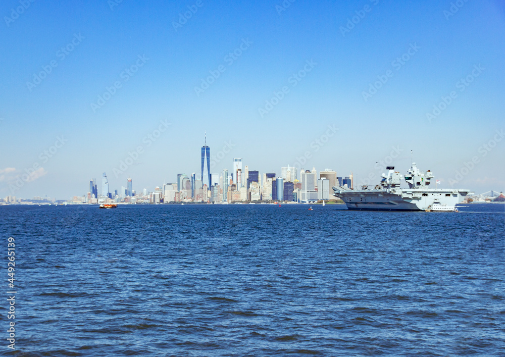 A picture of Manhattan skyline from Staten Island, NY, USA with an aircraft carrier A picture of Manhattan skyline from Staten Island, NY, USA with an aircraft carrier