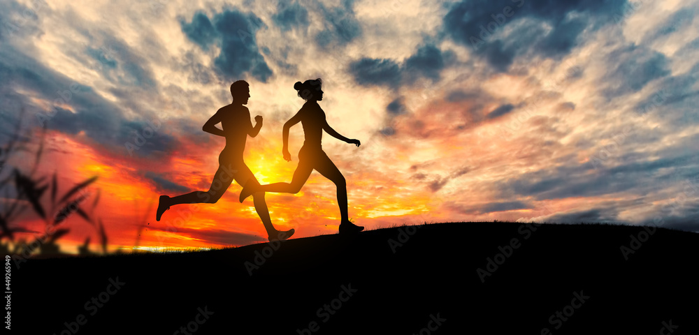 Young couple run together on a sunset