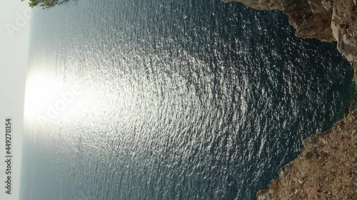 Scenic view on seascape from tall cliff during sunset, vertical video. photo