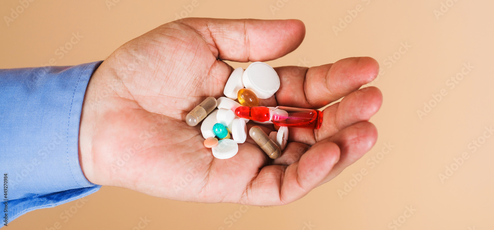 Medicine and treatments. Hand of man with pills. Drug therapy. Tablets prescribed by doctor. Medicine and treatments. Hand of man with pills. Drug therapy. Tablets prescribed by doctor.