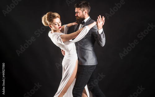 Couple dancing tango. Ballroom dance. Passion and love concept. photo