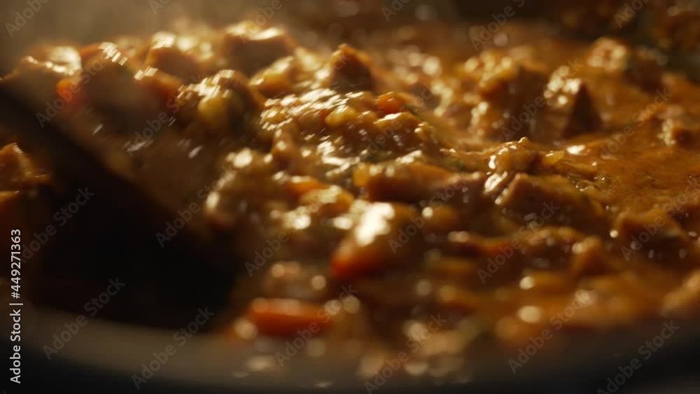 Close up of stewing beef and vegetables goulash in a pan. Concept of cooking tasty food. Close up of stewing beef and vegetables goulash in a pan. Concept of cooking tasty food.