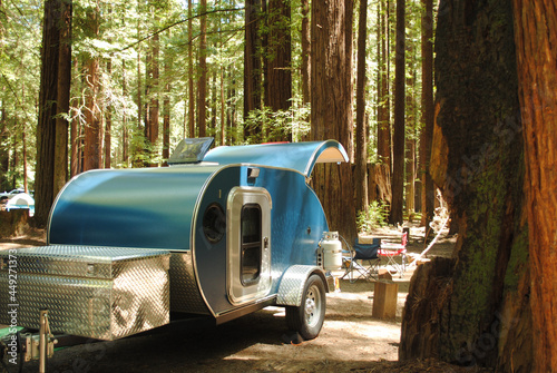 Front of a blue teardrop trailer in a redwood forest campground photo