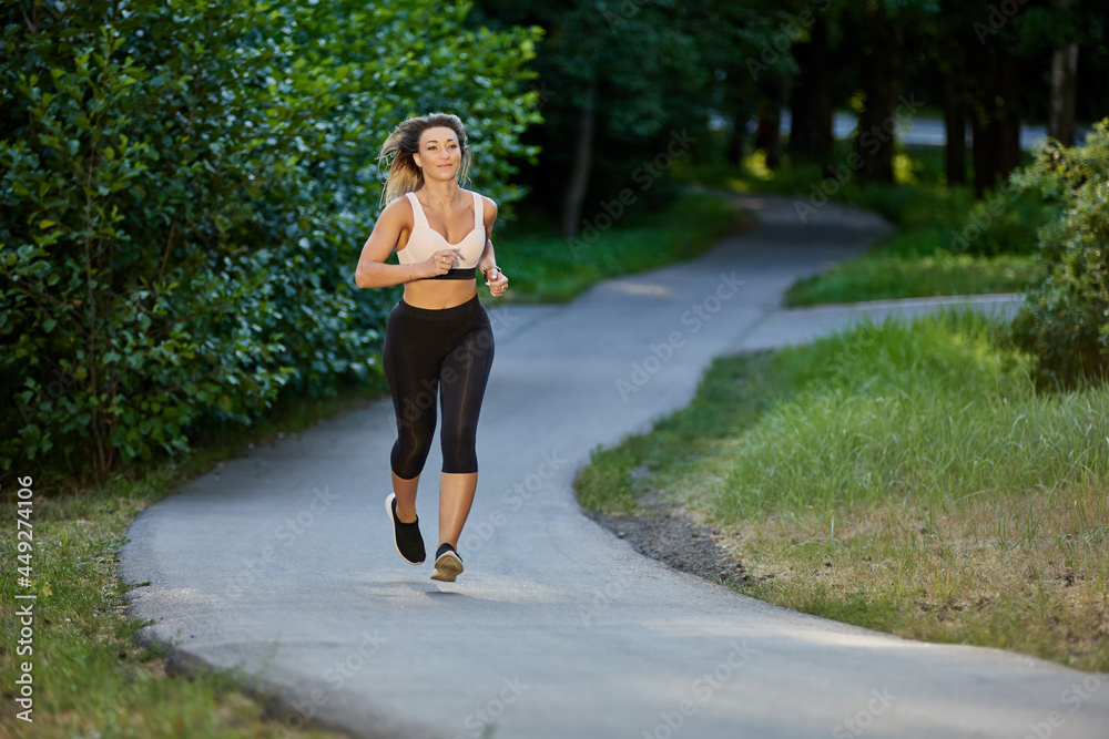 Sexy woman make jogging in summer park in evening. Sexy woman make jogging in summer park in evening.