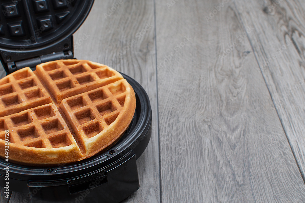 freshly made waffle in an open waffle iron freshly made waffle in an open waffle iron