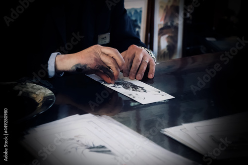 Fotografija Close-up of a skilled craftsman carving an emblem stamp in Guangzhou, China