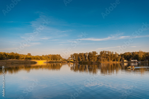 Pond with blue water and trees.