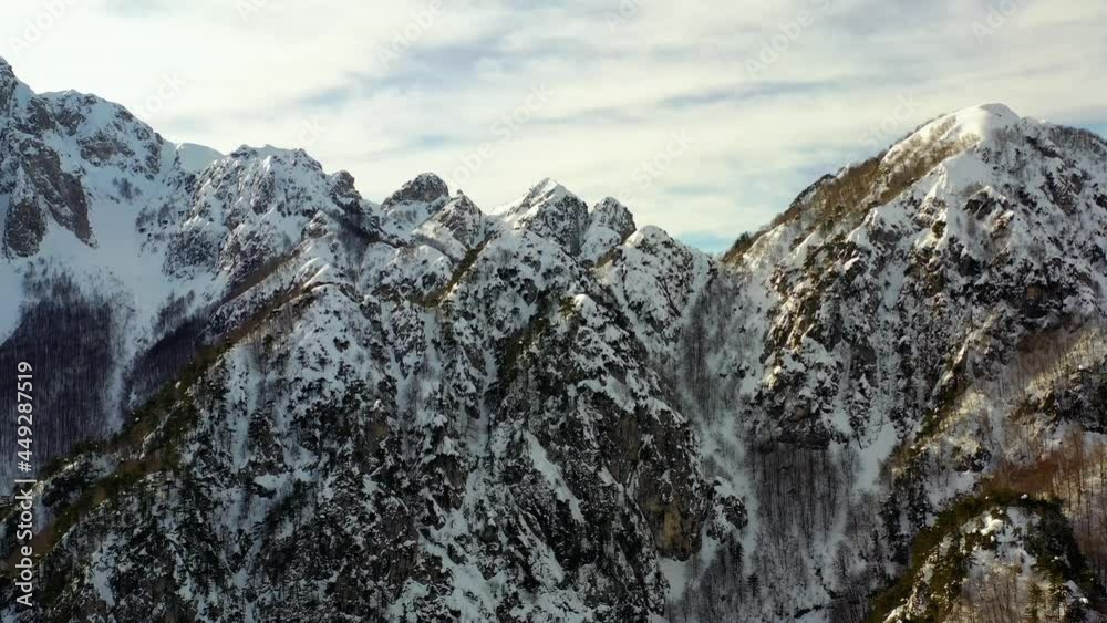 Aerial drone view closing in on steep, rocky, mountain peaks, in sunny Italy Aerial drone view closing in on steep, rocky, mountain peaks, in sunny Italy
