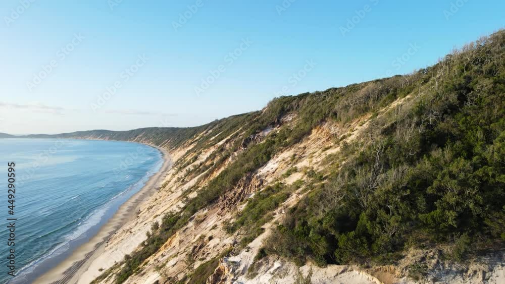 Revealing drone view of the constantly re-sculpt cliff lines of coloured sands at Rainbow Beach Queensland Australia Revealing drone view of the constantly re-sculpt cliff lines of coloured sands at Rainbow Beach Queensland Australia