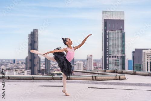ballerina dancer performing ballet dance on rooftop