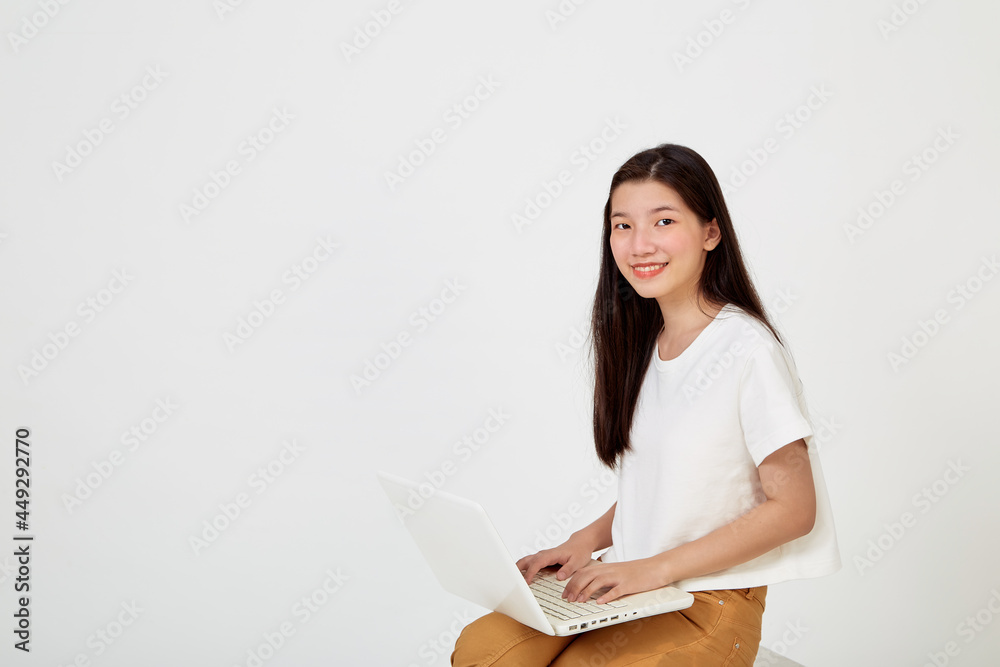 woman with laptop computer sitting cross legged and looking woman with laptop computer sitting cross legged and looking