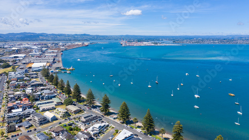 Aerial View from Houses close to the Beach, Green Trees, Mountain, Mount Maunganui, Boats in Tauranga, New Zealand  - Bay of Plenty photo