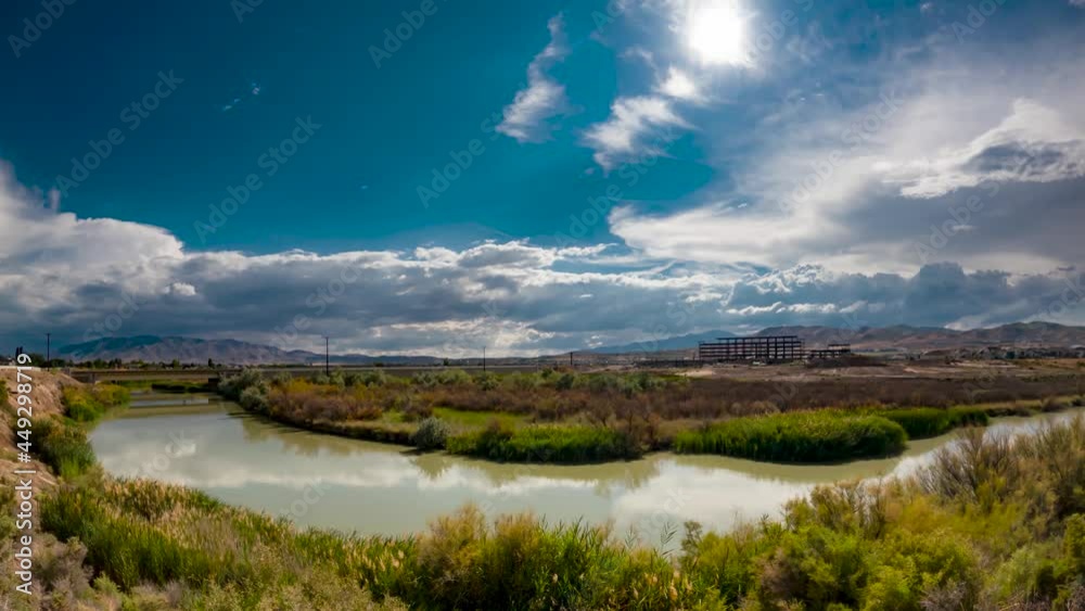 Billowing cloudscape in the sky and reflecting off the surface of the river - wide angle time lapse Billowing cloudscape in the sky and reflecting off the surface of the river - wide angle time lapse