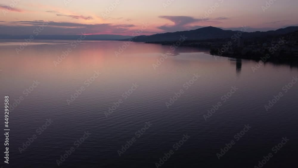 Expansive aerial shot high above Lake Geneva near Montreux, Switzerland during a vibrant sunset. Expansive aerial shot high above Lake Geneva near Montreux, Switzerland during a vibrant sunset.