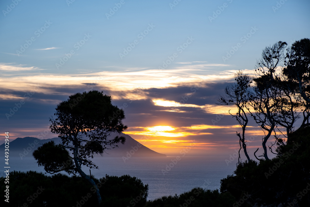 Sunset over Aegean sea at Milos island, Cyclades Greece.
