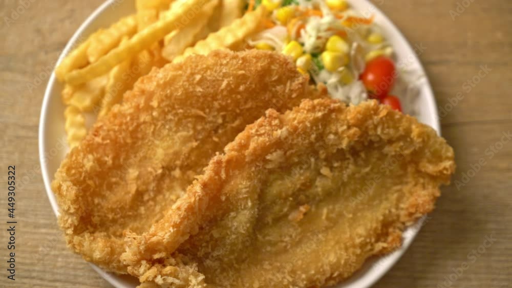 fish and chips with mini salad on white plate fish and chips with mini salad on white plate