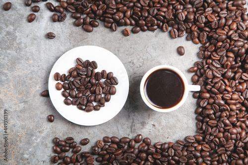 Cup of coffee on coffee beans.