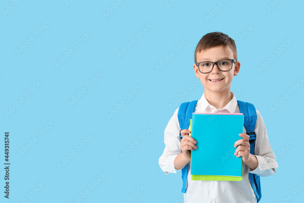 Little schoolboy with textbooks on color background Little schoolboy with textbooks on color background