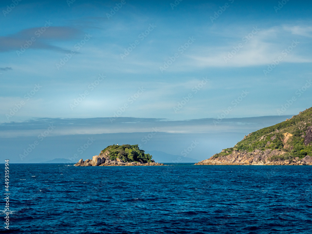 Rocky Island of the Coast on a Blue Sky Day