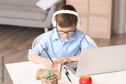 Focused schoolboy in headph...