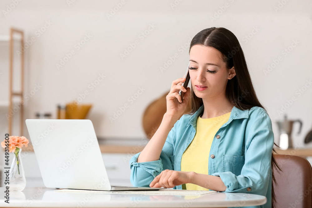 Young woman using laptop and mobile phone at home Young woman using laptop and mobile phone at home