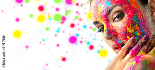 Fototapeta Naklejka Na Ścianę i Meble -  Fashion Model Girl colorful face paint. Beauty fashion art portrait, beautiful woman with painting smears, abstract makeup. Vivid paint make-up, bright colors. Multicolor creative make-up. Painter