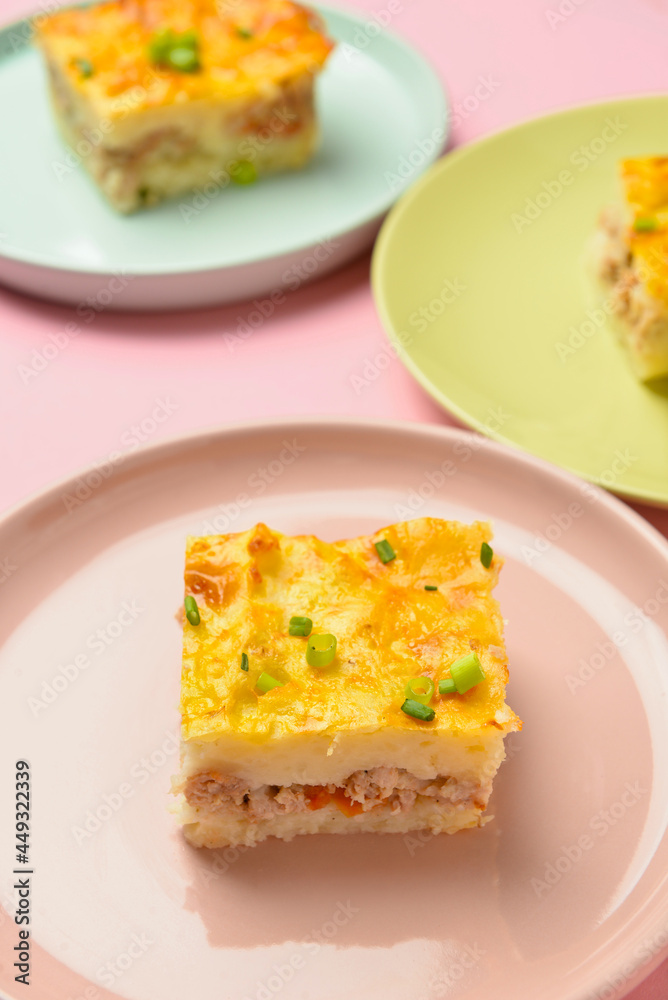 Plates with pieces of mashed potato casserole on color background, closeup Plates with pieces of mashed potato casserole on color background, closeup