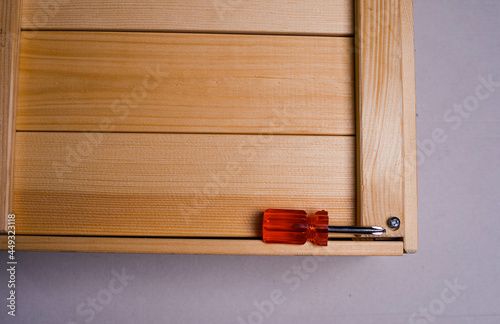 Obraz na plátně brown wooden box on a white background with a red phillips screwdriver background texture