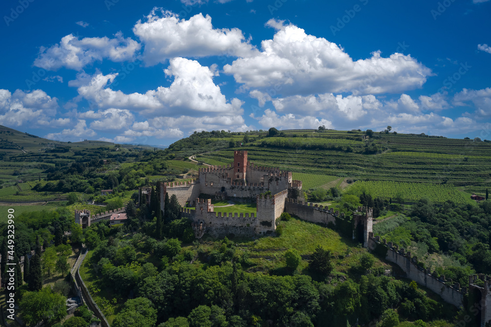 Aerial panorama of Italy castles. The famous medieval castle on the hill. Italian historic castles. Soave castle aerial view, province of Verona, Italy.