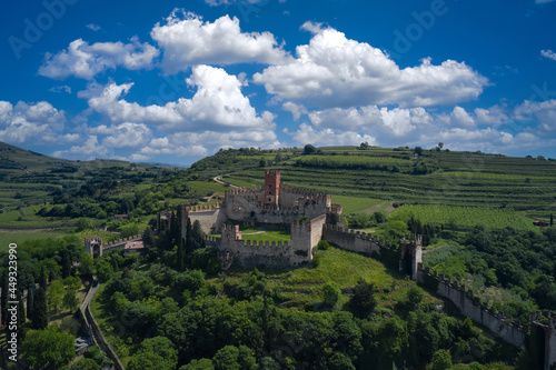 Aerial panorama of Italy castles. The famous medieval castle on the hill. Italian historic castles. Soave castle aerial view  province of Verona  Italy.