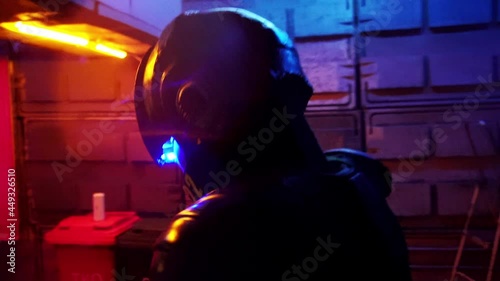 Cyberpunk concept, future world. Police officer halfman bionic cyborg is walking through night area of city. Science fiction scene, fantasy, sci. World of tomorrow. Neon lighting. Robot. Closeup photo