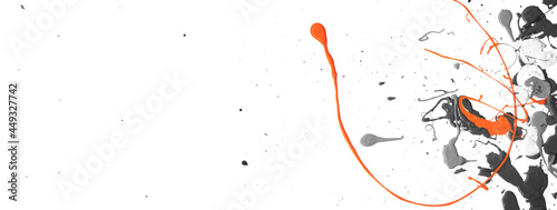 Detail of orange paint, color splash, on black and white acrylic paint background. Artistic banner