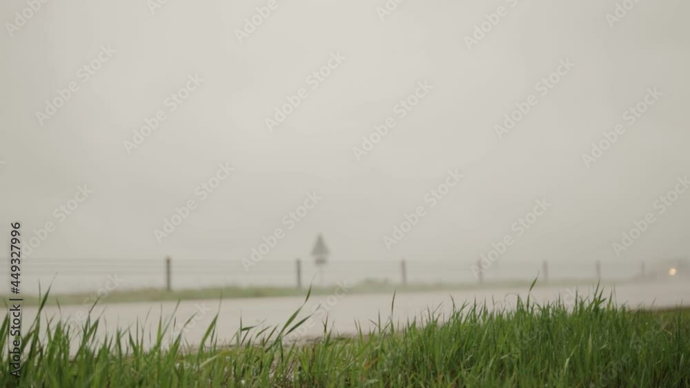 Black crossover driving on the motorway in rainy wet weather and semi-trailer trucks. Gray clouds, rain. Copy space for text, slow motion Black crossover driving on the motorway in rainy wet weather and semi-trailer trucks. Gray clouds, rain. Copy space for text, slow motion